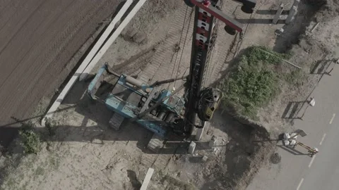 Pile driving machine driving piles into ground site. Stock Footage 231998768