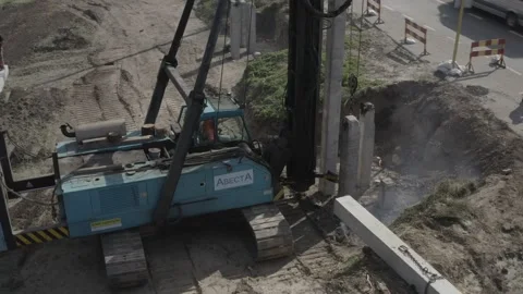 Pile driving machine driving piles into ground site. Stock Footage 231998820