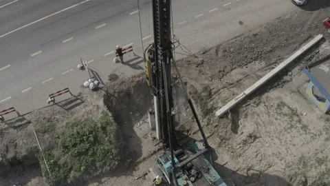 Pile driving machine driving piles into ground site. Stock Footage 231998830