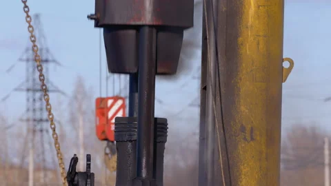 Pile driving machine with rumble and smoke drives piles deep into the ground Stock Footage 147632206