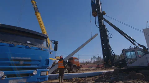 Pile driving machine with rumble and smoke drives piles deep into the ground Stock Footage 161956116