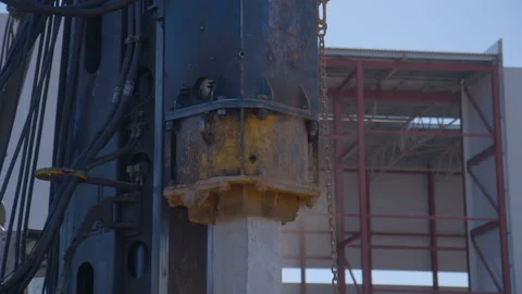 Pile driving machine with rumble and smoke drives piles deep into the ground Stock Footage 161956575