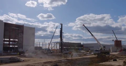 Pile driving machine with rumble and smoke drives piles deep into the ground Stock Footage 161957523
