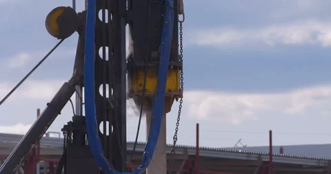 Pile driving machine with rumble and smoke drives piles deep into the ground Stock Footage 161957797