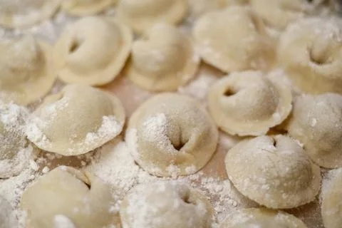 A pile of dumplings with flour on the table Stock Photos