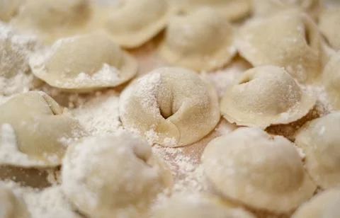 A pile of dumplings with flour on the table Stock Photos
