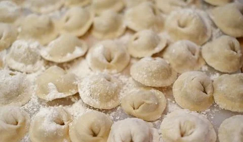 A pile of dumplings with flour on the table Stock Photos