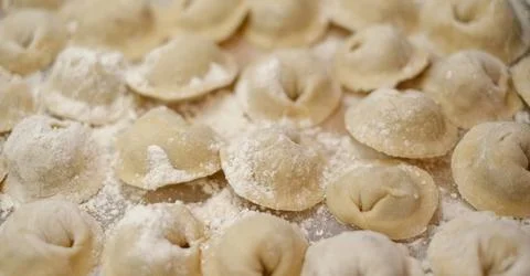 A pile of dumplings with flour on the table Stock Photos