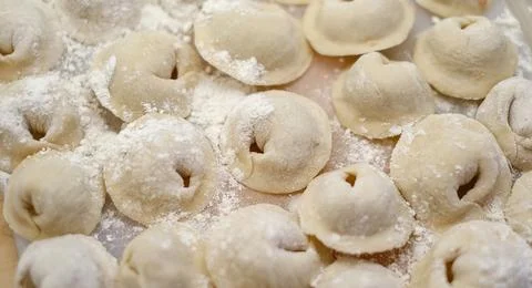 A pile of dumplings with flour on the table Stock Photos