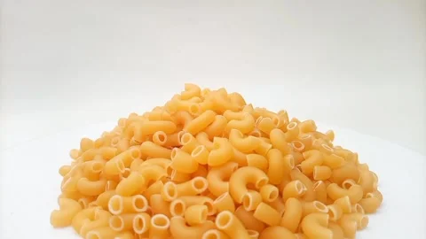 A Pile Of Elbow Macaroni Pasta Rotating on White Background, Uncooked Elbow.. 스톡 동영상 333667437
