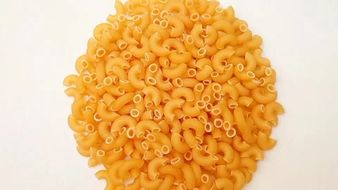 A Pile Of Elbow Macaroni Pasta Rotating on White Background, Uncooked Elbow.. Stock-Footage 333667470