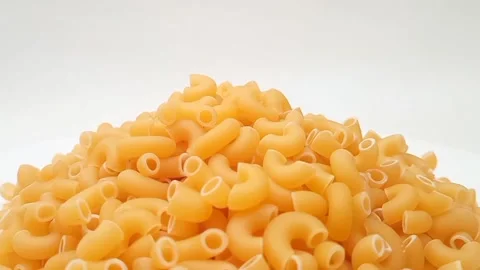 A Pile Of Elbow Macaroni Pasta Rotating on White Background, Uncooked Elbow.. 库存影片 333667471