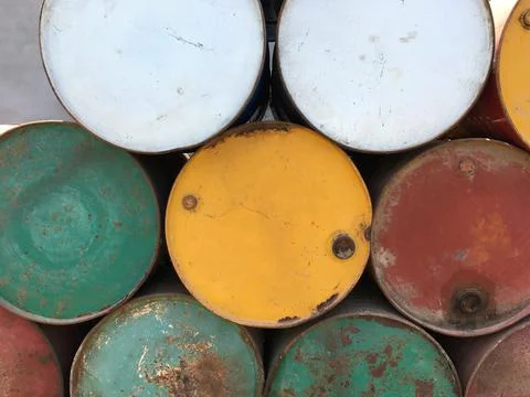 A pile of empty big rusty fuel metal barrels. Stock Photos