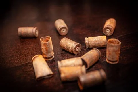 A pile empty bullet shells on a wooden background Stock Photos