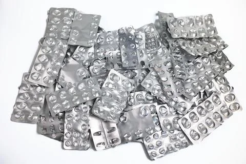 Pile of empty pill blister packs on white background. Treatment and medicatio Stock Photos