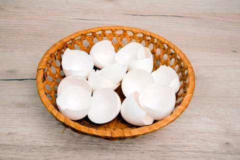 A pile of empty  white egg shells in wicker basket Stock Photos