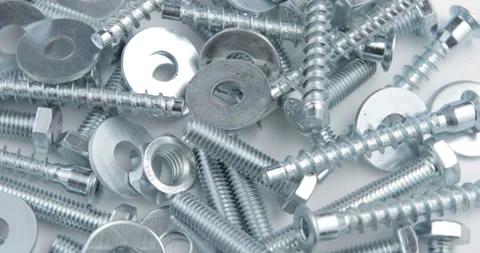 Pile of fastener with a threaded hole that forms a connection with a screw Stock Footage 97921812