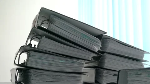 Pile of filed documents in arch files on table. Slide shot. Video stock 144977414