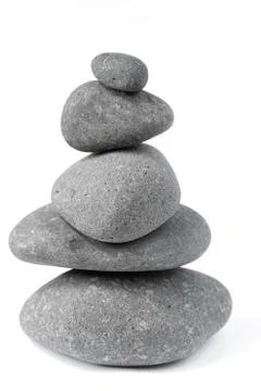 Pile of five balanced rocks on plain background Foto stock