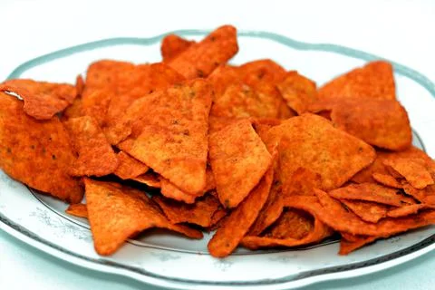 A pile of flavored tortilla chips made of corn tortillas cut into triangles Stock Photos