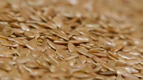 Pile of flax seeds on rotating table, macro view, healthy food Stock Footage 100505736