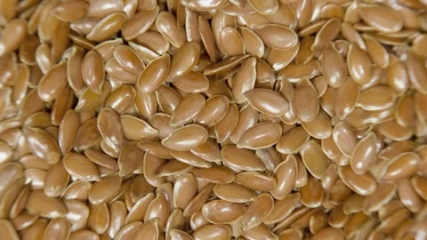 Pile of flax seeds on rotating table, macro view, healthy food Stock Footage 100535766