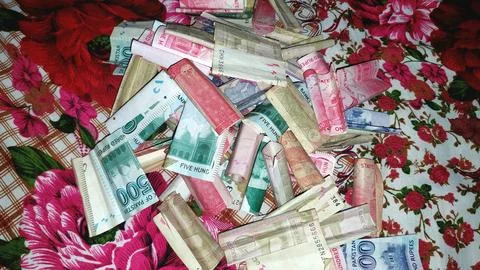 Pile Of Folded Pakistani Currency Notes Spread On Floral Surface Фото
