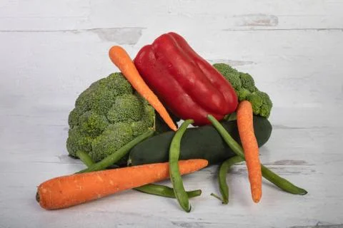 Pile of fresh raw vegetables on a rustic white wood background Stock Photos