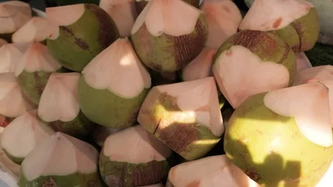 Pile of Fresh Young Coconuts Trimmed into Hexagonal Tops Ready for Drinking Stockbeeldmateriaal 345639150