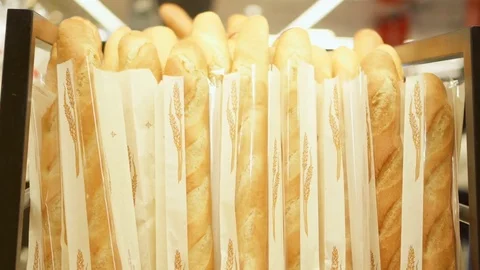 Pile of freshly made crisp baguettes at the bakery counter. Tasty fresh bread on Stock Footage