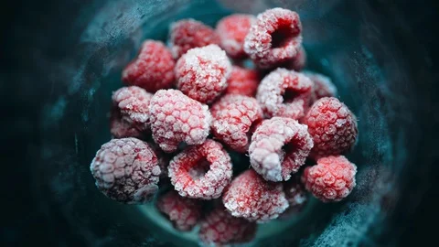 A pile of frozen raspberries is quickly defrosted in a glass. Healthy food. 4K Stock Footage