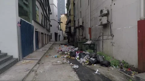 Pile of garbage between buildings on narrow side street, Kuala Lumpur, Malaysia Stock Footage 169386670