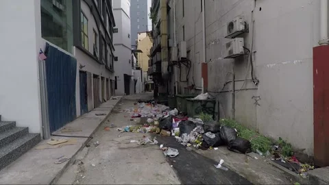 Pile of garbage between buildings on narrow side street, Kuala Lumpur, Malaysia Stock Footage 169386687