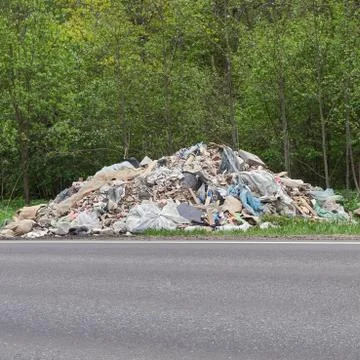 Pile of garbage lying on the roadside of russian countryside road Stock Photos