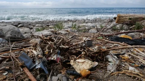 Pile of garbage lying on the seashore against the background of tides of sea Stock Footage 126658244