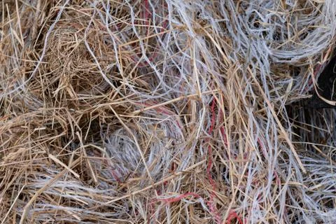 Pile of garbage, plastic threads of packing material of straw in a large pile Stock Photos