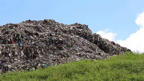 A pile of garbage from the surrounding community becomes a mountain of garbage Stock Footage 124304848
