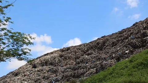 A pile of garbage from the surrounding community becomes a mountain of garbage Stock Footage 124304849