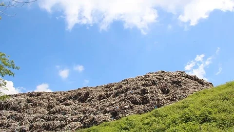 A pile of garbage from the surrounding community becomes a mountain of garbage Stock Footage 124305205