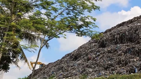 A pile of garbage from the surrounding community becomes a mountain of garbage Stock Footage 124305206