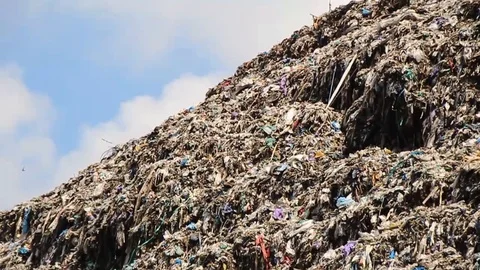 A pile of garbage from the surrounding community becomes a mountain of garbage Stock Footage 124305212