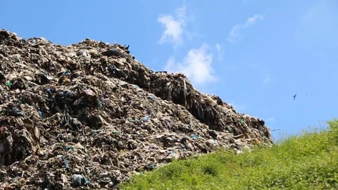 A pile of garbage from the surrounding community becomes a mountain of garbage Stock Footage 124305340