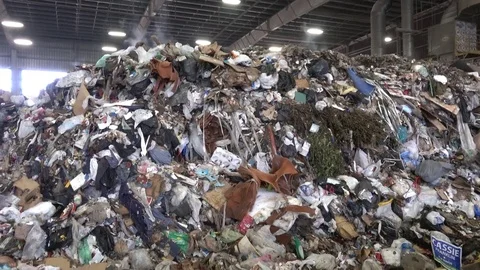 A pile of garbage in a transfer station releases steam Stock Footage 76168890