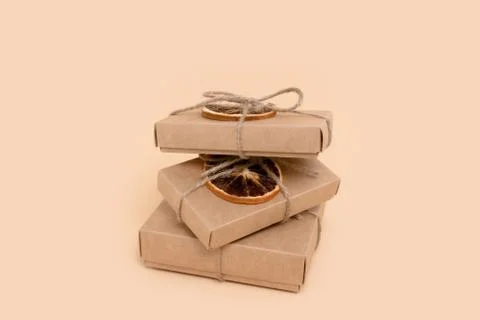 Pile of gift boxes on a beige background. Stock Photos