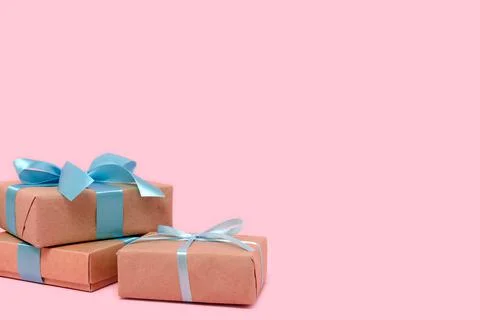 Pile of gift boxes in front of pink pastel background. Stock Photos