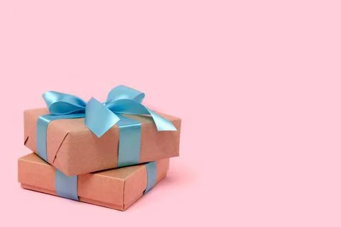 Pile of gift boxes in front of pink pastel background. Stock Photos