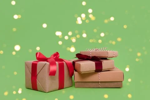 Pile of gift boxes on a grren background. Stock Photos