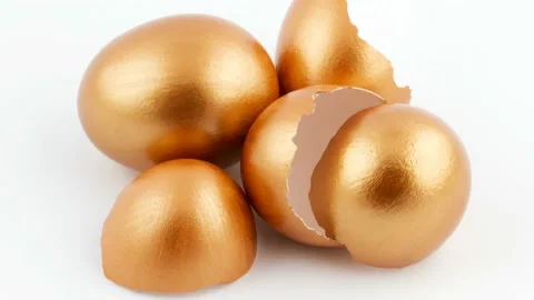 Pile of golden broken eggshells with eggs in 4K Stock Footage 233454491