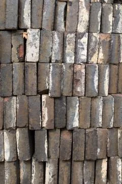 A pile of gray bricks ready for use, looking at the long edge of the bricks Stock Photos