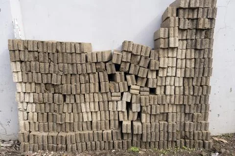 Pile of gray bricks stacked on top of each other Stock Photos